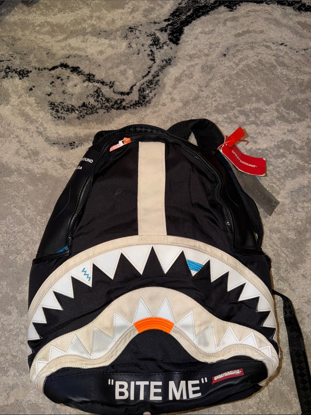 Sprayground Black Shark-Mouth Backpack with Cream and Orange Accents